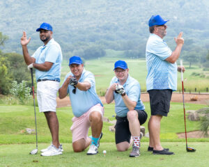 Four golfers in a silly pose pretending to be sharpshooters during a golf outing for clients before the South Africa Awards Gala in March 2025