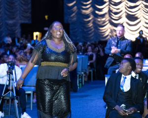 Lebo Nemalamangwa has a wide, confident smile as she walks up the center aisle to accept an award at the South Africa Awards Gala in March 2025