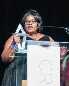 Lisedi Letlatsa speaks on stage from behind a podium as she accepts the Comeback Owner of the Year award at South Africa Awards Gala in March 2025