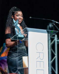 Mbhoni Ngobeni smiles from behind a podium while holding her award for Rookie Owner of the Year at the South Africa Awards Gala in March 2025