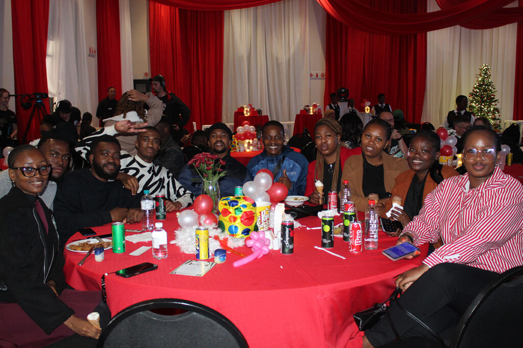 A table full of happy celebrants at Credico South Africa's 2025 Christmas in July
