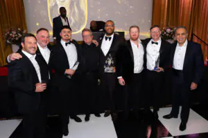 Leaders and award winners pose in a row for a group photo in front of the stage at the 2026 Limitless Kickoff Gala. Pictured are Jesse Young, James Sagar, Alexis Camarena, Peter van den Berg, Marques Aiken, Gavin Walsh, Tyler Basker, and Antoine Nohra.