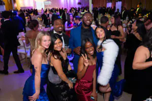 A smiling group of celebrating attendees takes a break from dancing at the 2026 Limitless Kickoff Gala