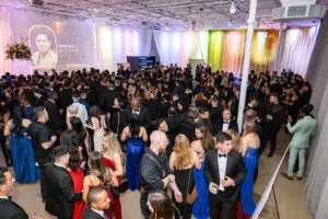 An overhead view of the crowd in their glittering finery during the champagne reception at the 2026 Limitless Kickoff Gala