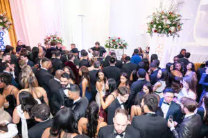 Attendees gather and mingle near the bar during the champagne reception at the 2026 Limitless Kickoff Gala
