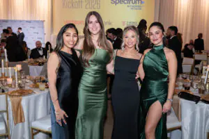Four stunningly successful women in black and green gowns pause for a photo during the 2026 Limitless Kickoff Gala